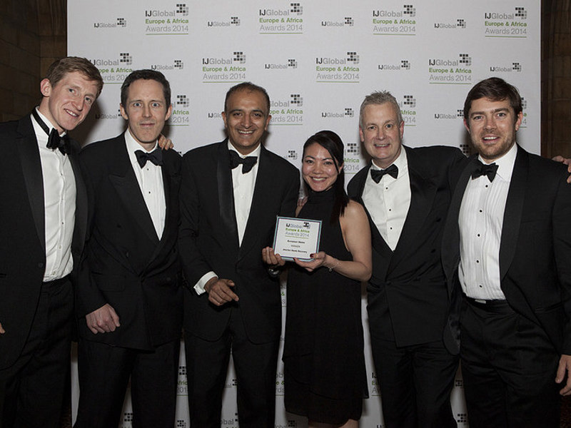 Amey employees, in formal attire, holding an award for European waste project of the year.
