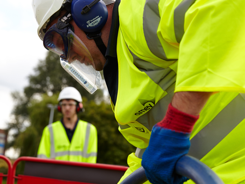 An amey employee in PPE carrying out water works.