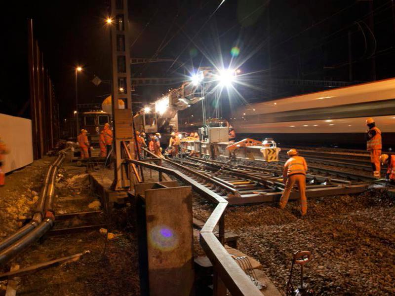Image of maintenance work being carried out on a rail track at night.