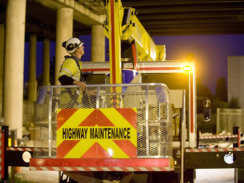 a man in PPE, on a highways maintenance lift.