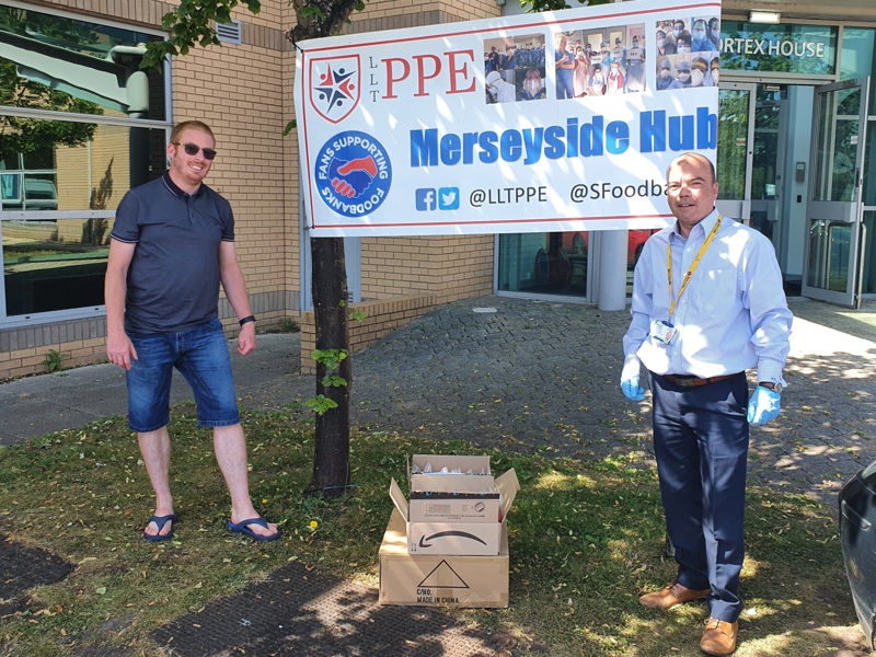 Two men stood in front of the Merseyside Hub.