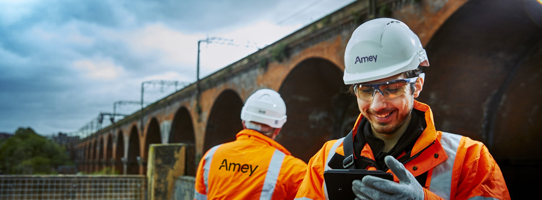 Two male Amey employees carrying out a bridge inspection