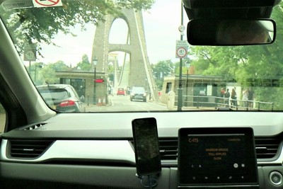 Image of a toll bridge through a car windscreen.
