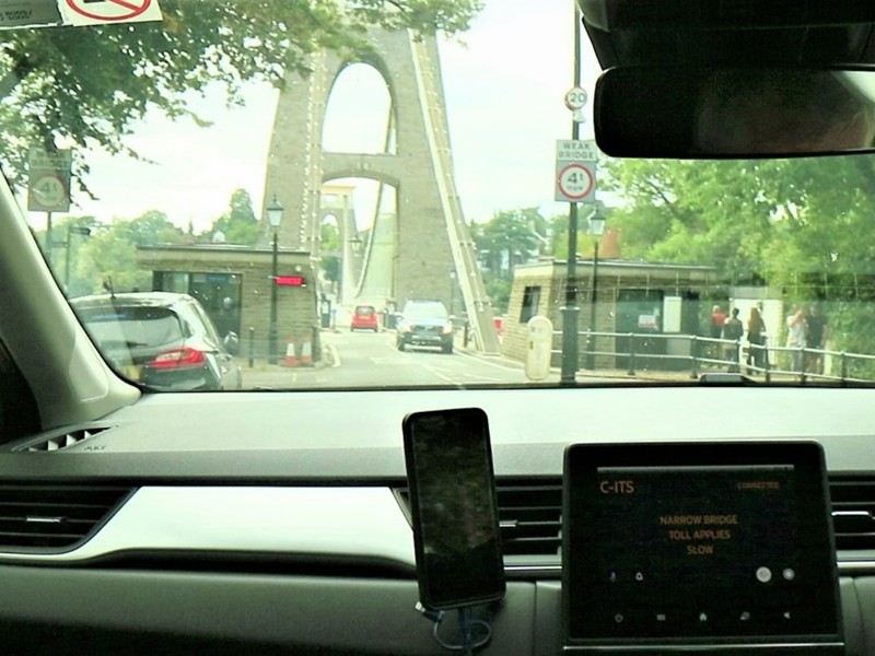 Image of a toll bridge through a car windscreen.