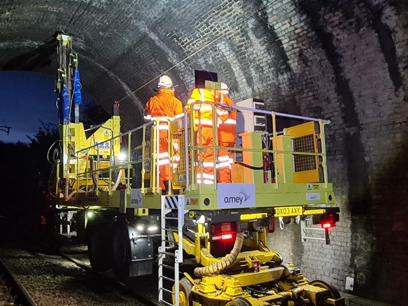 Men in PPE, carrying out maintenance of a tunnel.