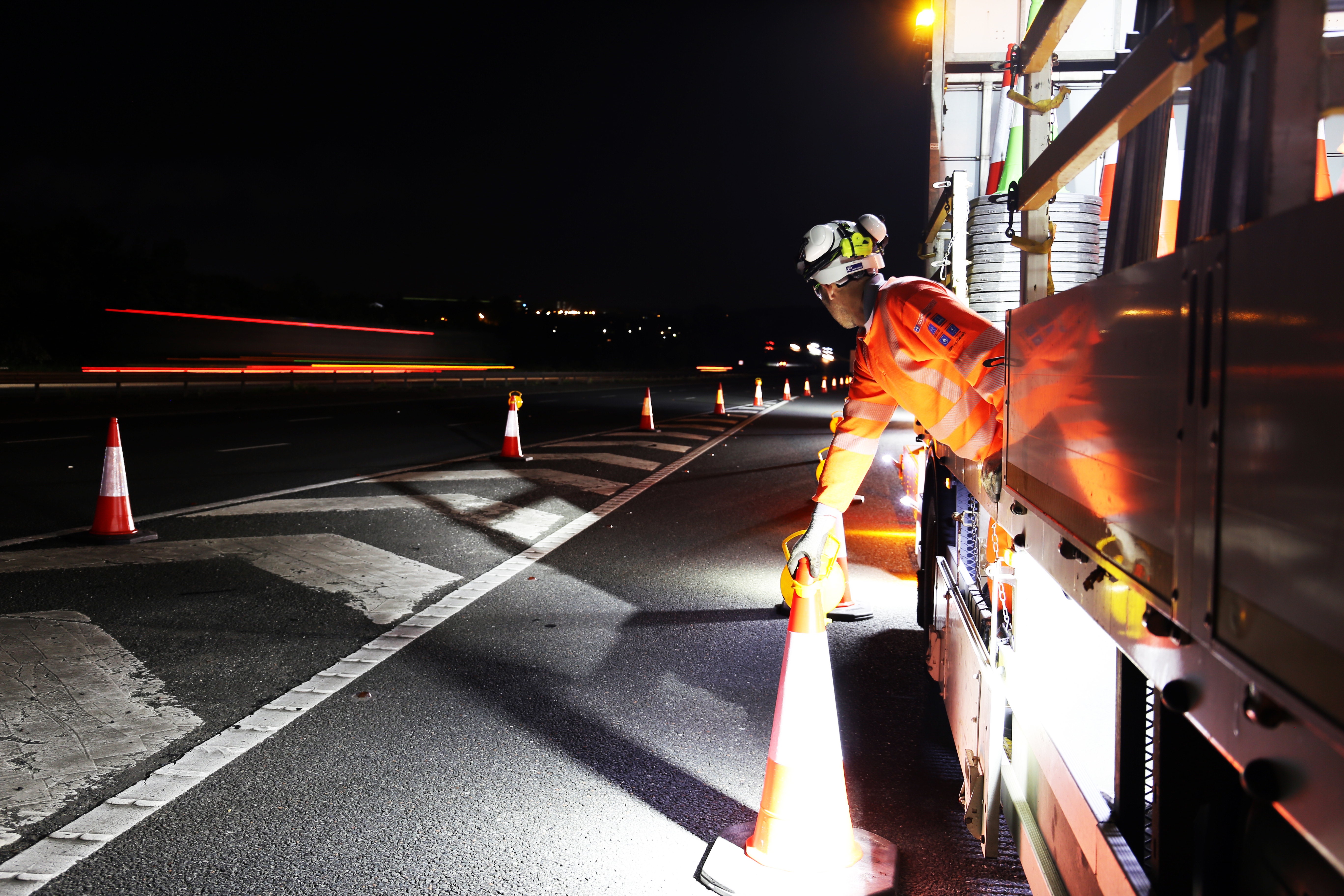 Highways worker, setting out traffic cones