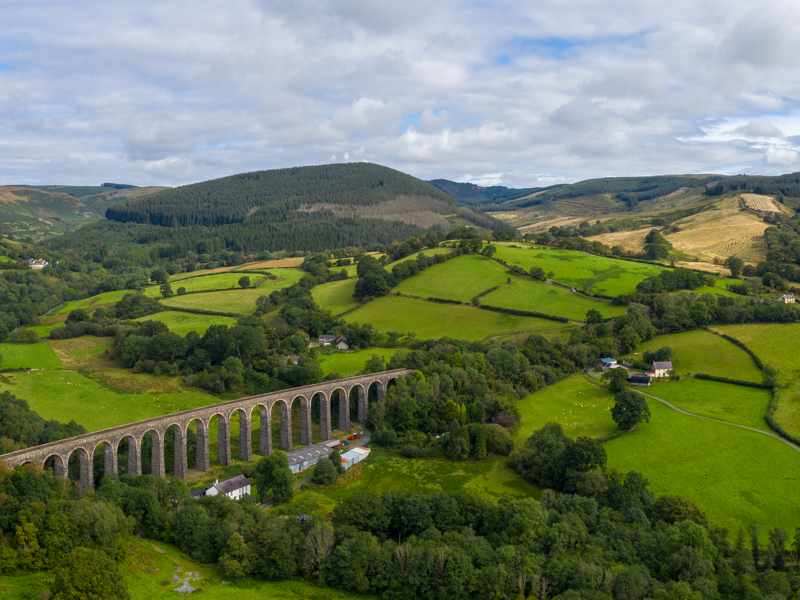 Landscape image of a scenic picture with a rail bridge and arches.