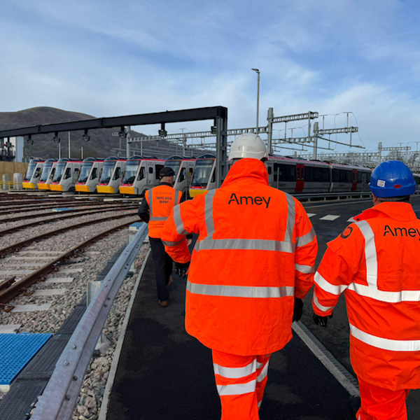 Two people in Amey PPE on a rail track