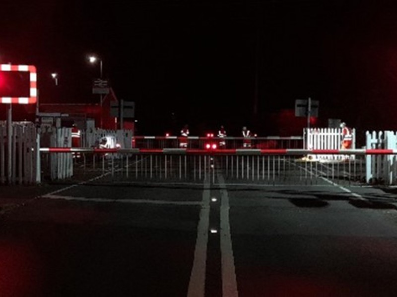 Rail crossing barriers at night.