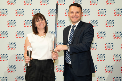 Image of two Amey employees holding an award and a sword.