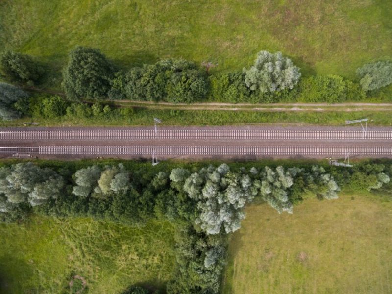 ariel view of a rail track surrounded by fields.