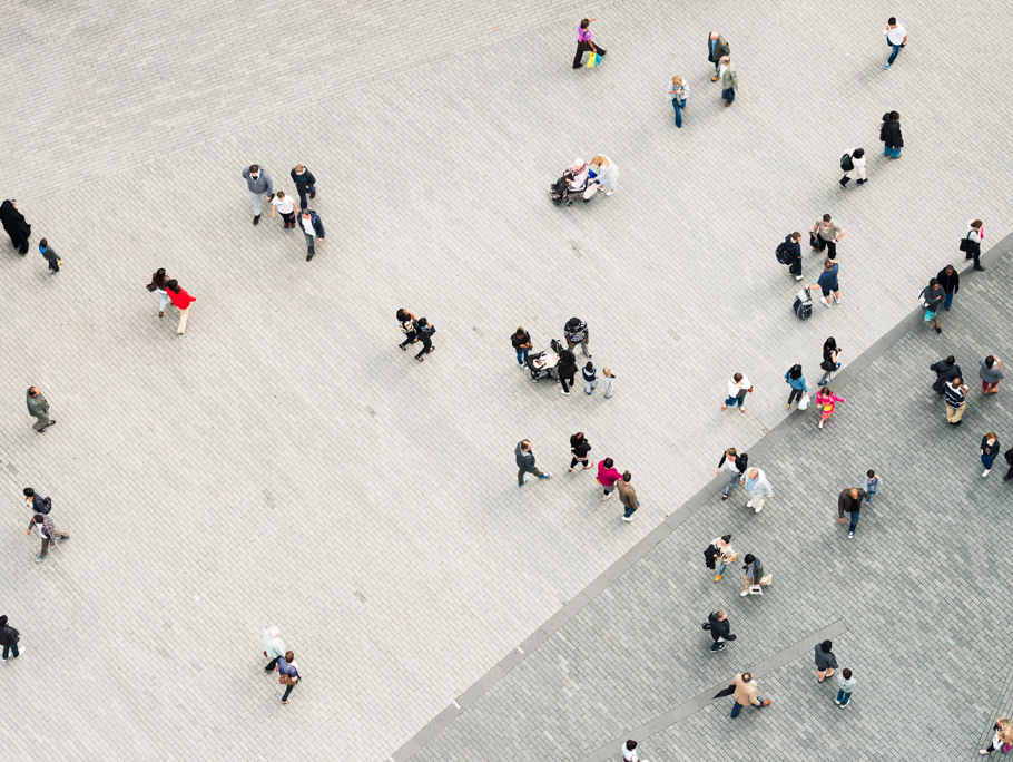 Ariel view of people walking in a paved area.