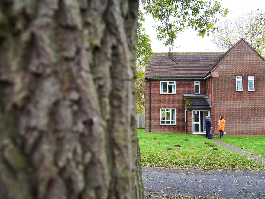 Two people standing in front of a house