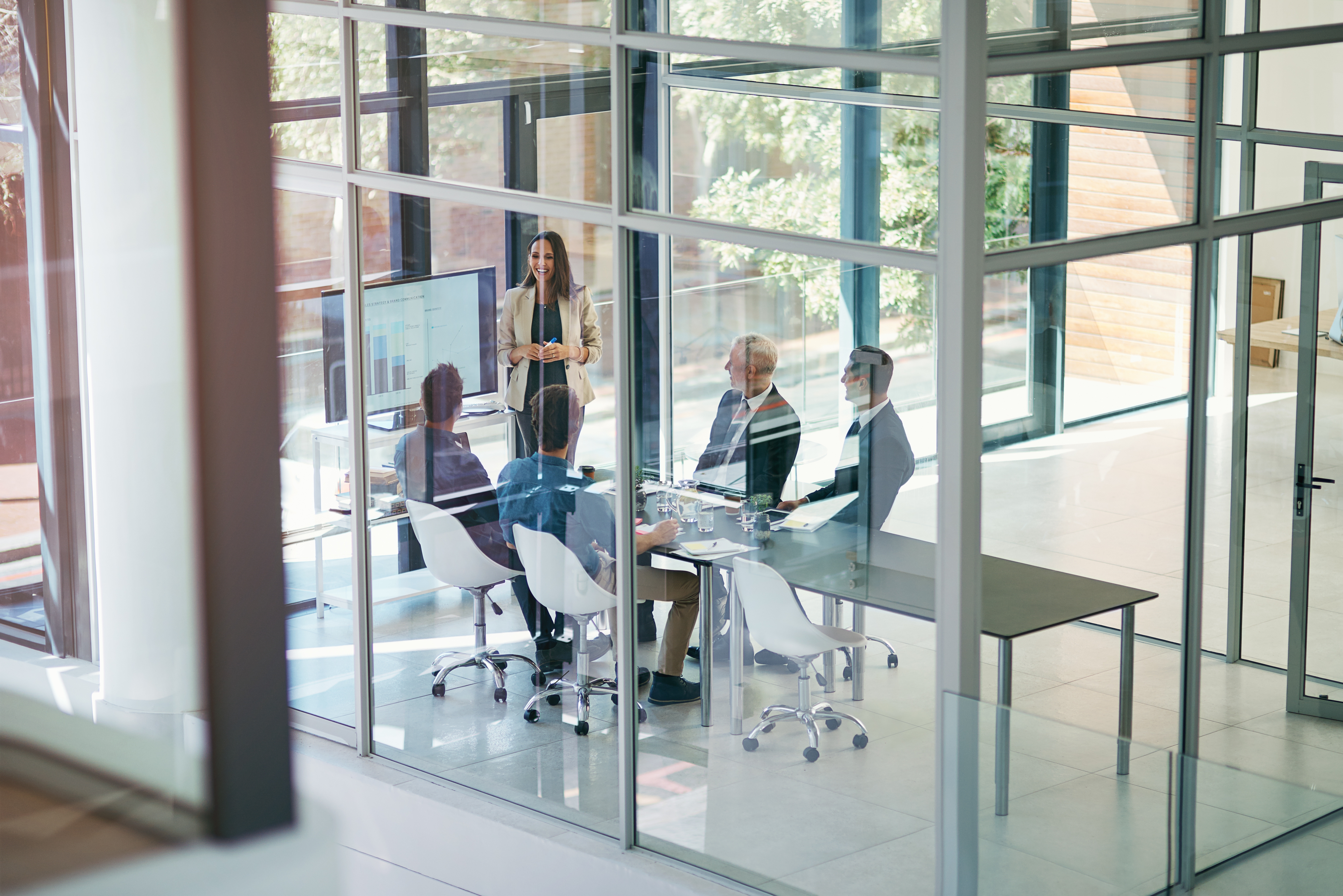 Image of employees in an office looking at a presentation