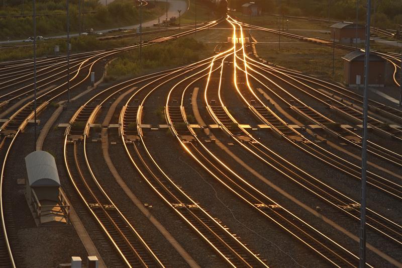 Rail tracks at sunset. 8 tracks merge into 1. 