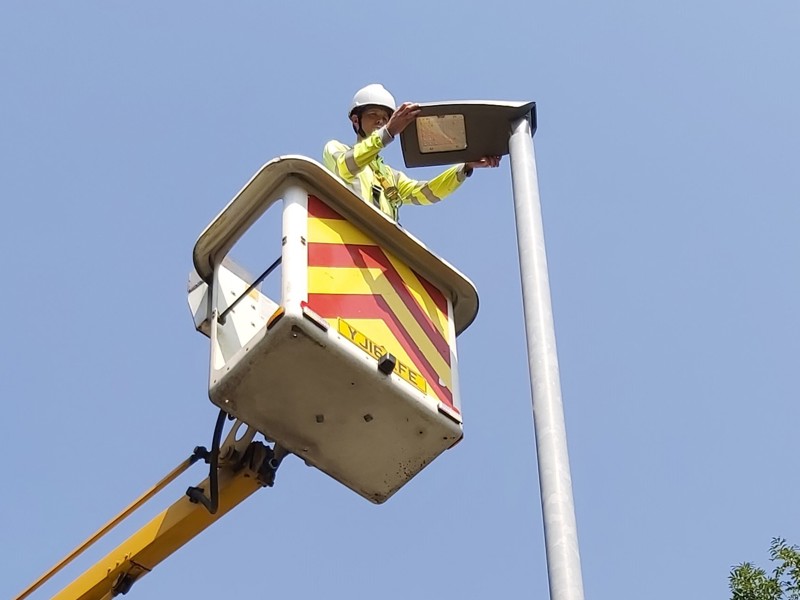man repairing a street light