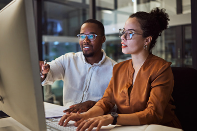 Image of two people working at computer