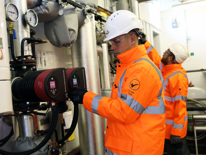 Two men in PPE.