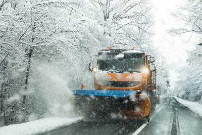 Image of gritters on a rural road in the snow