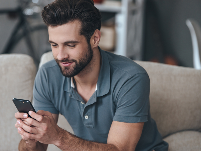 a man looking at his mobile phone.